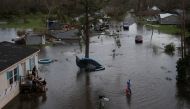 A man walks back to his home after sharing fuel with his neighbors, to use for their generator, in the aftermath of Hurricane Ida in Cut Off, Louisiana, U.S., August 30, 2021. Picture taken with a drone. REUTERS/Adrees Latif