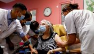 Health workers speak with Mauricette, a 78-year-old French woman, after she received the first dose of the Pfizer-BioNTech coronavirus disease (COVID-19) vaccine in the country, at the Rene-Muret hospital in Sevran, on the outskirts of Paris, France, Dece