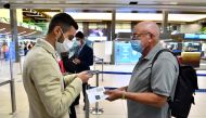 A man shows his COVID-19 certificate at Linate Airport in Milan, Italy, September 1, 2021. REUTERS/Flavio Lo Scalzo