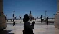 A person takes a picture in Lisbon downtown amid the coronavirus disease (COVID-19) pandemic, in Lisbon, Portugal, June 24, 2021. REUTERS/Pedro Nunes/File Photo