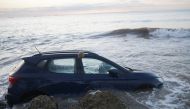 A car is seen in the sea after floods caused by heavy rains in Alcanar, Spain September 2, 2021. REUTERS/Lorena Sopena