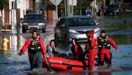 First responders pull local residents in a boat as they perform rescues of people trapped by floodwaters after the remnants of Tropical Storm Ida brought drenching rain, flash floods and tornadoes to parts of the northeast in Mamaroneck, New York, U.S., S
