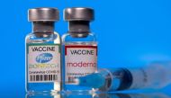Vials with Pfizer-BioNTech and Moderna coronavirus disease (COVID-19) vaccine labels are seen in this illustration picture taken March 19, 2021. REUTERS/Dado Ruvic/Illustration/File Photo