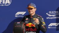 Red Bull's Max Verstappen poses with a tire after qualifying in pole position Pool via REUTERS/Francisco Seco