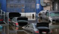 FILE PHOTO: Cars sit in water after flooding on the Major Deegan Expressway spilled over into the neighboring street and flooded a parking lot, when the remnants of Tropical Storm Ida brought drenching rain and the threat of flash floods and tornadoes to 