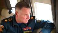 Russia's Emergencies Minister Yevgeny Zinichev sits in a helicopter as he accompanies President Vladimir Putin in a flight over wildfires sites in Chelyabinsk region, Russia August 6, 2021. Picture taken August 6, 2021. Sputnik/Alexei Nikolsky/Kremlin via