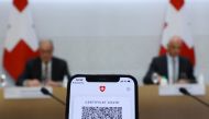A COVID certificate is pictured on a mobile device during the news conference of Swiss Interior Minister Alain Berset and Guy Parmelin President of the Swiss Confederation on the outbreak of the coronavirus disease (COVID-19) in Bern, Switzerland, Septemb