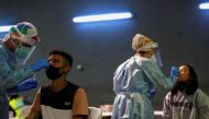 Health workers take swabs during a voluntary antigen test for the coronavirus disease (COVID-19) of young people coming back from vacationing in Salou at the bus station in Pamplona, Spain, July 4, 2021. REUTERS/Susana Vera
