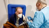  An elderly man receives a dose of the Moderna vaccine against the coronavirus disease (COVID-19) at the Music Auditorium in Rome, Italy, February 15, 2021. REUTERS/Guglielmo Mangiapane/File Photo