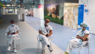 Health workers wait after receiving their injections with a dose of the Pfizer-BioNTech COVID-19 vaccine, as the coronavirus disease (COVID-19) outbreak continues, at Enfermera Isabel Zendal hospital in Madrid, Spain January 11, 2021. Picture taken throug