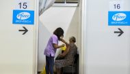 A healthcare worker administers the third dose of Pfizer's coronavirus disease (COVID-19) vaccine to a woman at Belgrade Fair vaccination center in Belgrade, Serbia, August 25, 2021. REUTERS/Zorana Jevtic./File Photo