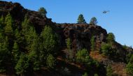 An emergency helicopter of the Government of the Canary Islands flies over an area where seismic movements are being felt in El Paso, on the Canary Island of La Palma, Spain, September 18, 2021. REUTERS/Borja Suarez