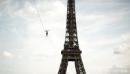 French acrobat Nathan Paulin walks on a slackline between the Eiffel Tower and the Theatre National de Chaillot as part of events around France for National Heritage Day in Paris, France, September 18, 2021. Reuters/Benoit Tessier
