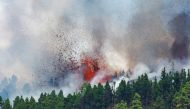 Lava and smoke rise following the eruption of a volcano in the Cumbre Vieja national park at El Paso, on the Canary Island of La Palma, September 19, 2021. REUTERS/Borja Suarez
