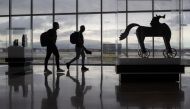 Passengers walk past artwork between terminals at IAH George Bush Intercontinental Airport amid the coronavirus disease (COVID-19) outbreak in Houston, Texas, U.S., July 21, 2020. REUTERS/Adrees Latif

