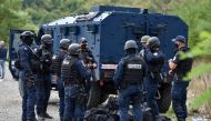 Kosovo special police with armoured vehicles are pictured as hundreds of Kosovo Serbs protest against a government ban on entry of vehicles with Serbian registration plates in Jarinje, Kosovo, September 21, 2021. REUTERS/Laura Hasani