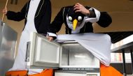 File photo: Climate activists dressed as penguins sit on refrigerators during a protest outside the European Commission headquarters in Brussels, March 12, 2009. Reuters/Francois Lenoir (Belgium) /File Photo