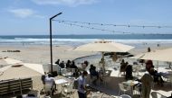 People sit at an outdoor restaurant terrace on the first day that tourists from Britain and most EU countries are allowed to enter Portugal without needing to quarantine, as coronavirus disease (COVID-19) restrictions continue to ease, by the Matosinhos B