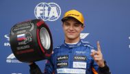 McLaren's Lando Norris celebrates pole position after qualifying Pool via REUTERS/Yuri Kochetkov

