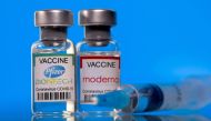 Vials with Pfizer-BioNTech and Moderna coronavirus disease (COVID-19) vaccine labels are seen in this illustration picture taken March 19, 2021. REUTERS/Dado Ruvic/Illustration/File Photo