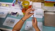 A healthcare worker prepares a dose of the Pfizer coronavirus disease (COVID-19) vaccine at a vaccination centre in Seixal, Portugal, September 11, 2021. REUTERS/Pedro Nunes/File Photo