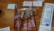 Syringes filled with a dose of the Moderna COVID-19 vaccine sit on a table during an employee vaccination at the Sarasota Memorial Hospital in Sarasota, Florida, U.S., September 24, 2021. REUTERS/Shannon Stapleton