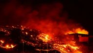 Lava burns buildings following the eruption of the Cumbre Vieja volcano in Tacande, Spain, October 9, 2021. Reuters/Juan Medina