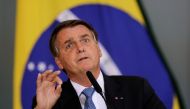 FILE PHOTO: Brazil's President Jair Bolsonaro gestures during the ceremony for the Modernization of Occupational Health and Safety Regulations, at the Planalto Palace in Brasilia, Brazil October 7, 2021. REUTERS/Ueslei Marcelino/File Photo
