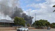 Smoke billows after a plane crash in Santee, California, U.S., October 11, 2021. Courtesy of Ryan Graves/Handout via REUTERS