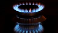 FILE PHOTO: Flames from a gas burner are reflected on a cooker in a private home in Bad Honnef near Bonn, Germany, October 11, 2021. REUTERS/Wolfgang Rattay/File Photo
