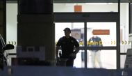 A police personnel stands at an entrance of the University of California Irvine Douglas Hospital, after former U.S. President Bill Clinton was admitted to the UCI Medical Center, in Orange, California, U.S. October 14, 2021. REUTERS/David Swanson