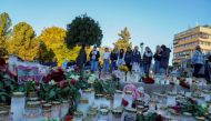 People lay down flowers and light candles to honour the dead, after a man killed five people in the city on Wednesday night, at Stortorvet in Kongsberg, Norway October 15, 2021. Terje Bendiksby/NTB/via REUTERS