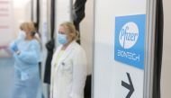 Healthcare workers wait in front of booths where people receive a dose of Pfizer's coronavirus disease (COVID-19) vaccine at Belgrade Fair vaccination center in Belgrade, Serbia, October 15, 2021. REUTERS/Marko Djurica
