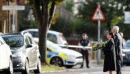 Britain's Home Secretary Priti Patel holds flowers as she arrives at the scene where British MP David Amess was stabbed to death, in Leigh-on-Sea, Britain, October 16, 2021. Reuters/Peter Nicholls