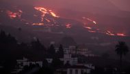 Lava spewed by the Cumbra Vieja volcano flows down a hill as the volcano continues to erupt on the Canary Island of La Palma, as seen from Tajuya, Spain, October 16, 2021. REUTERS/Sergio Perez