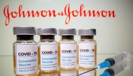Johnson & Johnson on Tuesday raised its annual adjusted profit forecast, but stuck to its COVID-19 vaccine sales target of $2.5 billion as it works its way through production challenges that have resulted in delays.