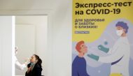 A woman undergoes a free coronavirus disease (COVID-19) rapid antigen test at a testing centre in the State Department Store, GUM, in Moscow, Russia October 18, 2021. REUTERS/Maxim Shemetov/File Photo