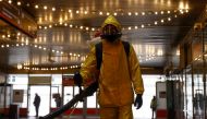 A specialist wearing personal protective equipment (PPE) sprays disinfectant while sanitizing the Leningradsky railway station amid the outbreak of the coronavirus disease (COVID-19) in Moscow, Russia October 19, 2021. REUTERS/Maxim Shemetov
