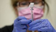 A nurses fills up syringes for patients as they receive their coronavirus disease (COVID-19) booster vaccination during a Pfizer-BioNTech vaccination clinic in Southfield, Michigan, U.S., September 29, 2021. REUTERS/Emily Elconin