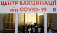 People wait to receive a vaccine against the coronavirus disease (COVID-19) outside a vaccination centre in Kyiv, Ukraine October 21, 2021. REUTERS/Valentyn Ogirenko
