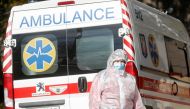 A medical specialist is seen next to an ambulance outside a hospital for patients infected with the coronavirus disease (COVID-19) in Kyiv, Ukraine October 21, 2021. REUTERS/Valentyn Ogirenko
