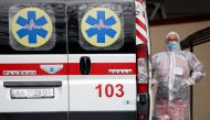 A health worker stands near an ambulance carrying a COVID-19 patient, as they wait in the queue at a hospital for people infected with the coronavirus disease in Kyiv, Ukraine October 18, 2021. Reuters/Gleb Garanich/File Photo