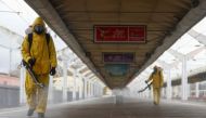 Specialists wearing personal protective equipment (PPE) spray disinfectant while sanitizing the Leningradsky railway station amid the outbreak of the coronavirus disease (COVID-19) in Moscow, Russia October 19, 2021. REUTERS/Maxim Shemetov