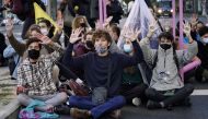 Climate activists sit on a road during a protest by Extinction Rebellion against the COP26 summit in Madrid, Spain, October 25, 2021. Reuters/Juan Medina