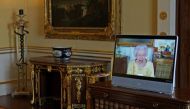 Britain's Queen Elizabeth appears on a screen via video link from Windsor Castle, where she is in residence, during a virtual audience to receive the Ambassador from the Republic of Korea, Gunn Kim, at Buckingham Palace, London, Britain, October 26, 2021.