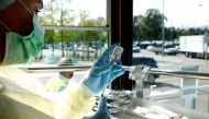 A health worker draws Moderna coronavirus disease (COVID-19) vaccine into a syringe inside the COVID-19 Impftram vaccination tram during a media presentation in Zurich, Switzerland September 14, 2021. REUTERS/Arnd Wiegmann/File Photo