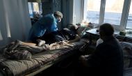 A medical specialist treats a patient suffering from the coronavirus disease (COVID-19) at the intensive care unit (ICU) of the City Clinical Hospital Number 3 in Kyiv, Ukraine October 26, 2021. REUTERS/Stanislav Kozliuk