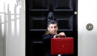 Britain's Chancellor of the Exchequer Rishi Sunak holds the budget box outside Downing Street in London, Britain, October 27, 2021. REUTERS/Peter Nicholls