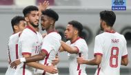 Qatar U-23 players celebrate after drawing their last AFC U23 Asian Cup Uzbekistan 2022 Group qualifier against Syria, yesterday. Unbeaten Qatar topped Group A to qualify for next year's tournament.