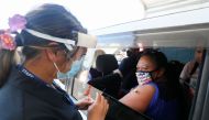 A member of the public receives a Pfizer vaccine at a drive-through coronavirus disease (COVID-19) vaccination clinic in Otara during a single-day vaccination drive, aimed at significantly increasing the percentage of vaccinated people in the country, in Auckland, New Zealand, October 16, 2021. REUTERS/Simon Watts